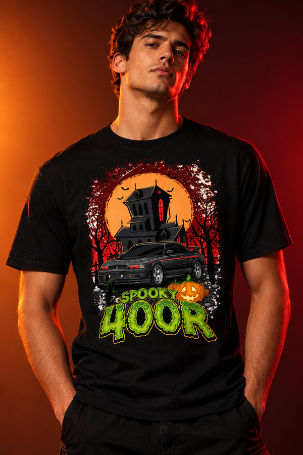 Halloween-themed graphic with a black car, haunted house, and pumpkin, featuring the text 'Spook 400R'.